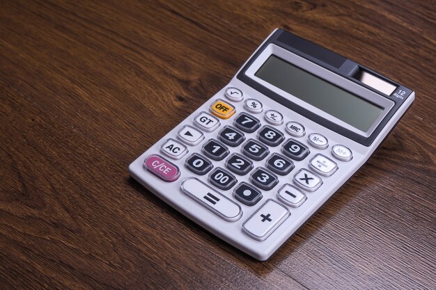 Calculator keypad on a wooden floor background. Top view. Copy space