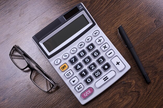 Calculator keypad on a wooden floor background