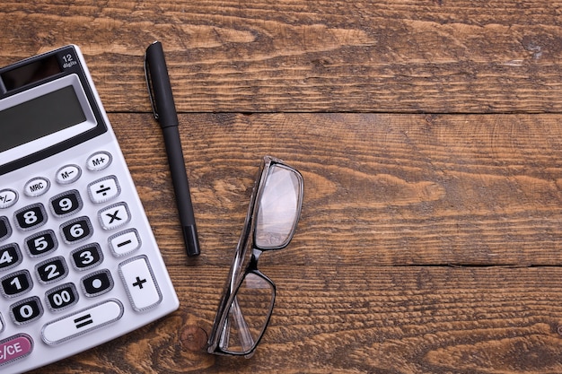 Calculator keypad on a wooden floor background