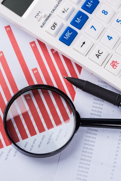 Calculator and magnifying glass on the table