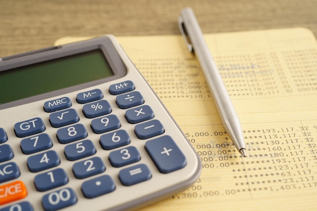 calculator and pen on bookbank finance