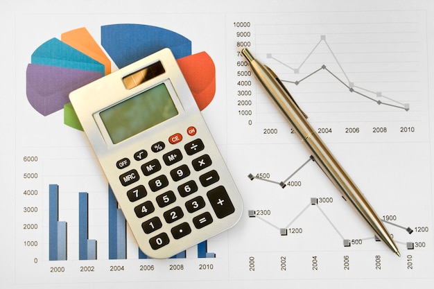 Calculator and pen on a business background