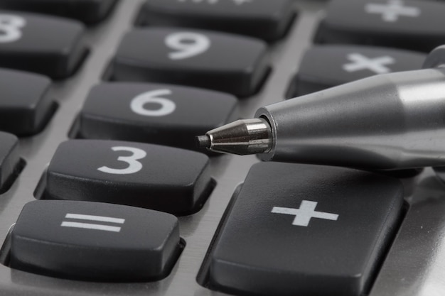 calculator and pen on a business background