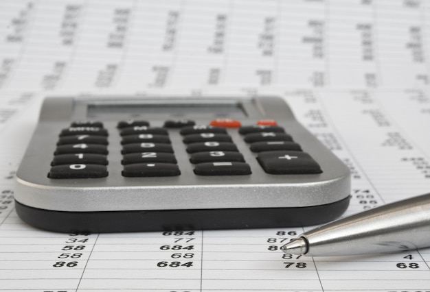 Premium Photo | Calculator and pen on a business background