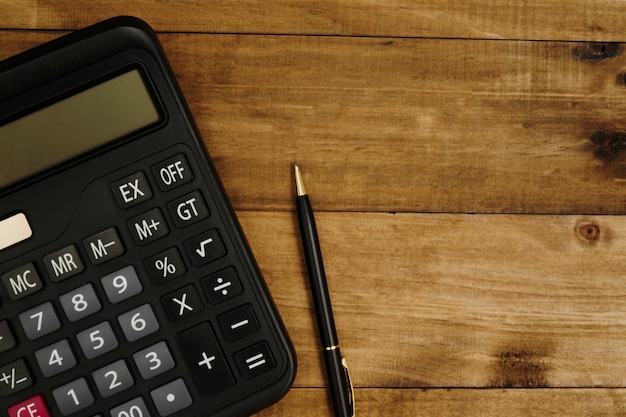 Calculator next to pen ready to calculate