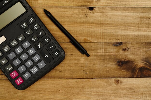 Calculator next to pen ready to work