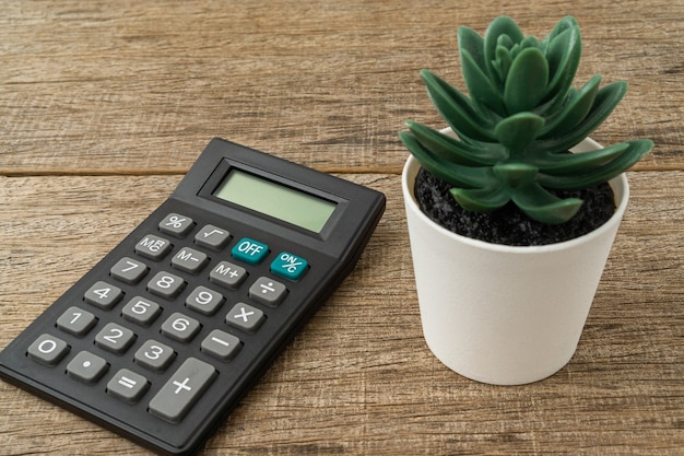 A calculator on shabby wooden board.