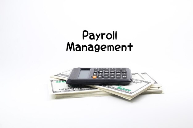 A calculator sits on top of a stack of money with the words paypal management on it.