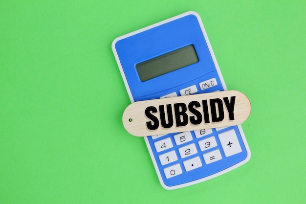 Photo calculator and a stick with the word subsidy the concept of getting subsidies business concept