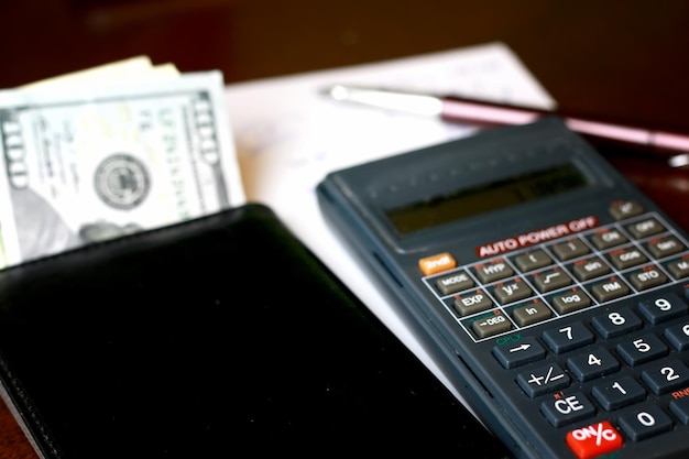 Calculator on the table glasses money