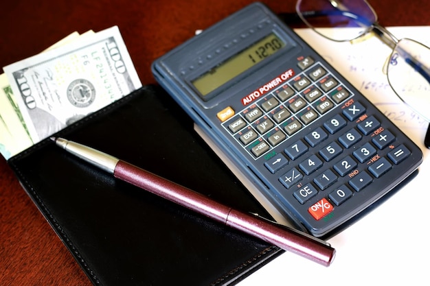 Calculator on the table glasses money