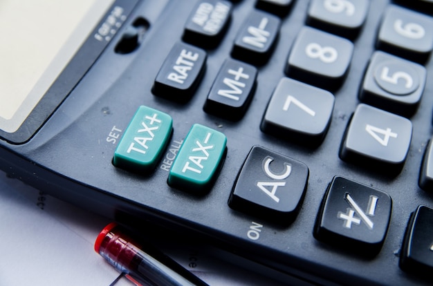 calculator and tax button and red pen 