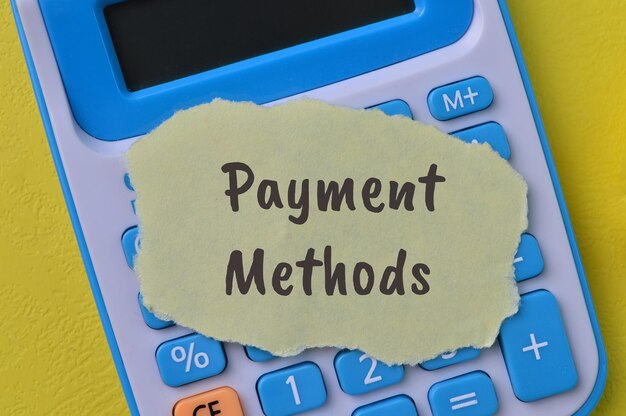 Calculator and torn paper with text PAYMENT METHODS