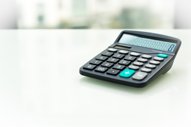 Calculator on the white table near window