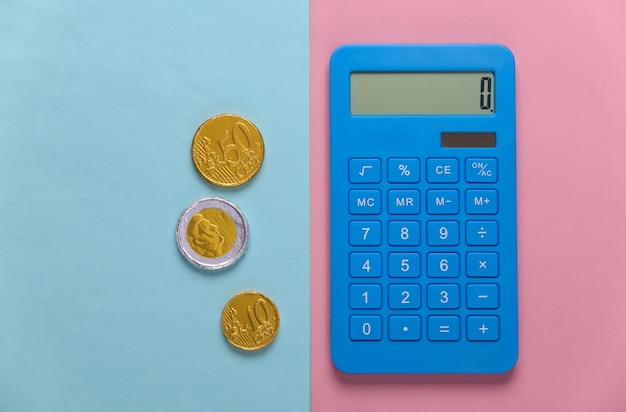 Calculator with coins on pink blue pastel