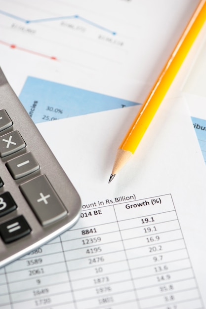 Calculator with documents on a table desk