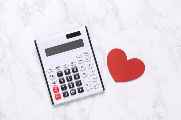 Calculator with heart on marble background