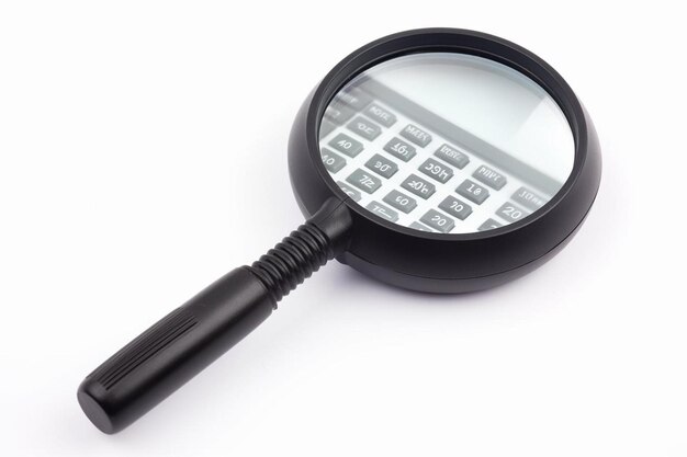 Calculator with a magnifying glass on a white background