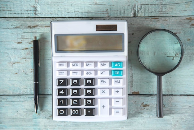 Calculator with pen and magnifier