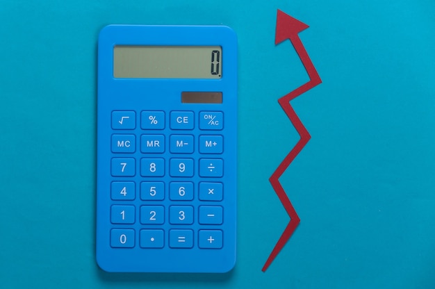 Calculator with red growth arrow on blue. Arrow graph going up. The economic growth