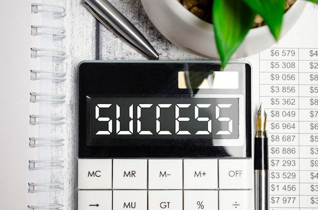 Calculator with word SUCCESS on its display Business concept