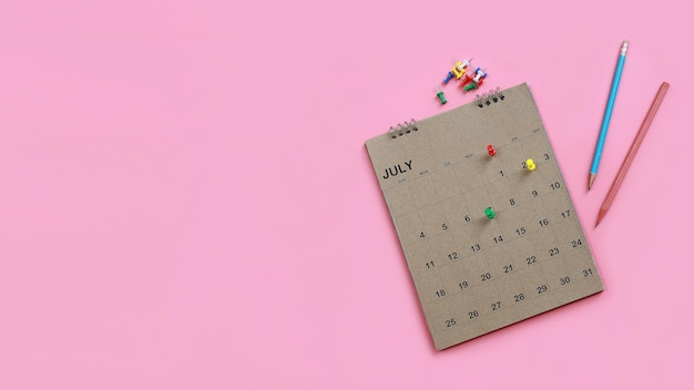 Calendar and appointment scheduler with a pin on a pink background