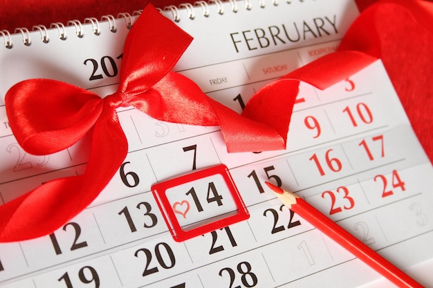 Calendar by february 14 painted red heart background