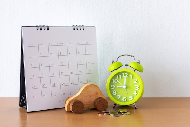 Calendar and car on table. Day of buying or selling a car or payment for rent or loan or repair