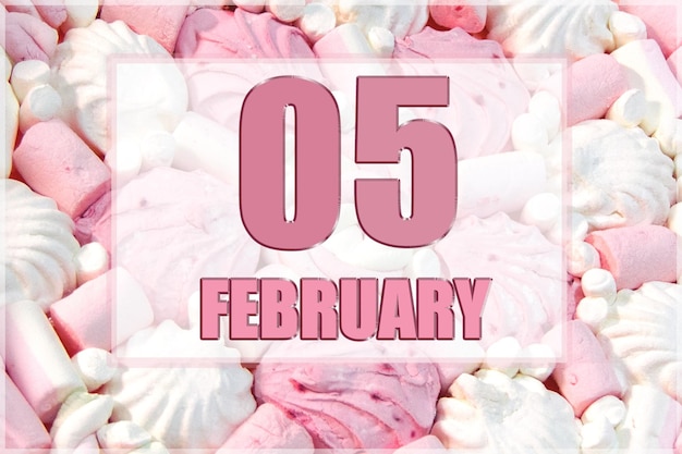 Calendar date on the background of white and pink marshmallows February 5 is the fifth day of the month