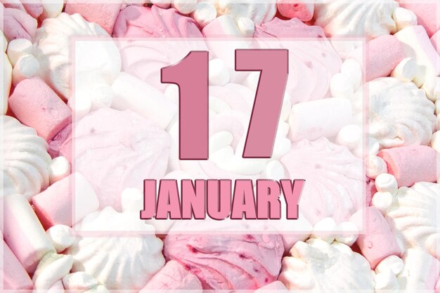 Calendar date on the background of white and pink marshmallows January 17 is the seventeenth day of the month