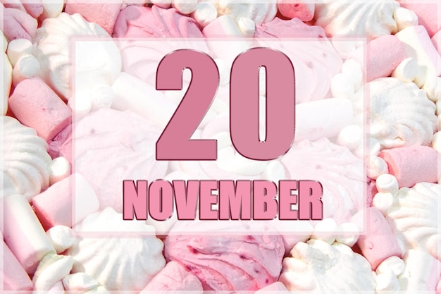 Calendar date on the background of white and pink marshmallows November 20 is the twentieth day of the month