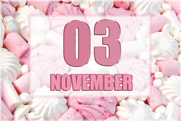 Calendar date on the background of white and pink marshmallows November 3 is the third day of the month