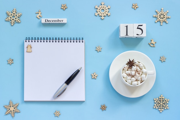 Calendar December 15 cup cocoa and marshmallow, empty open notepad