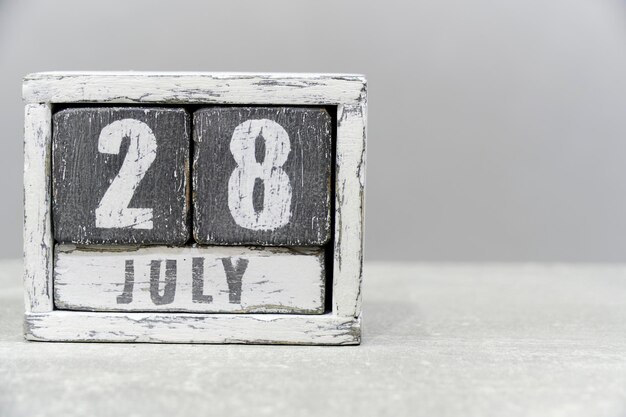 Calendar for July 28 made of wooden cubes on gray backgroundWith an empty space for your textHepatitis Day