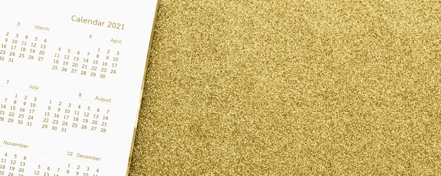 Photo calendar page close up on gold glitter sparkle
