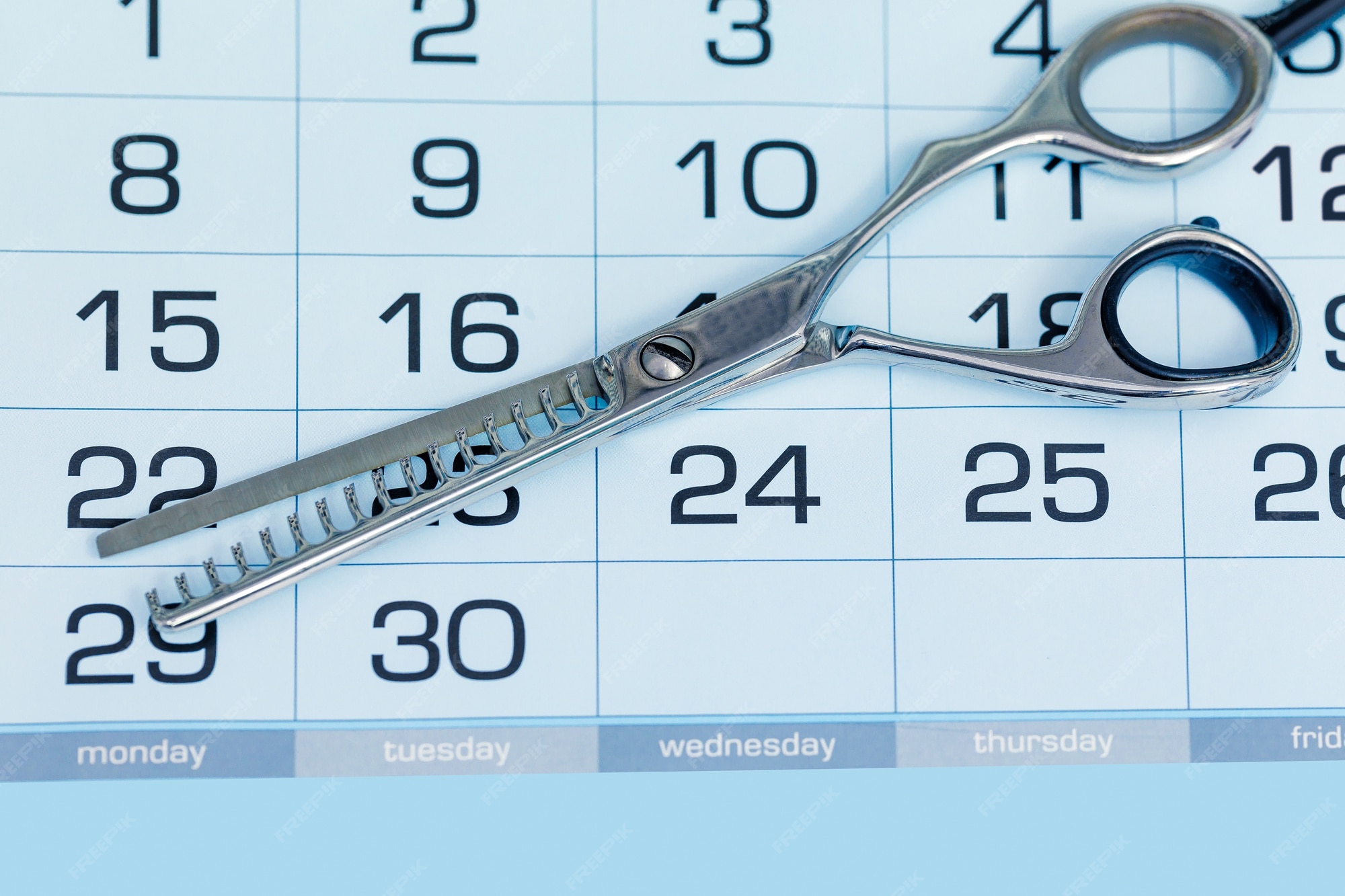 Premium Photo Calendar with hairdressing scissors. haircut