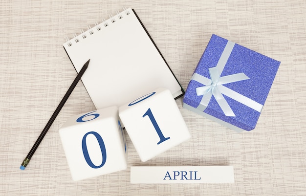 Calendar with trendy blue text and numbers for April 1 and a gift in a box.