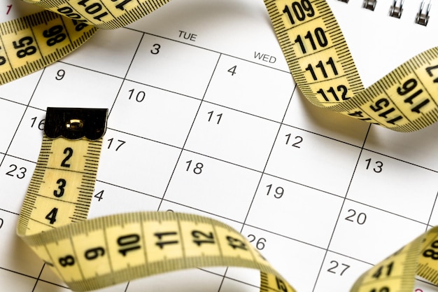 Calendar and yellow measuring tape