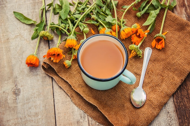 Calendula tea and flowers. Selective focus. nature.