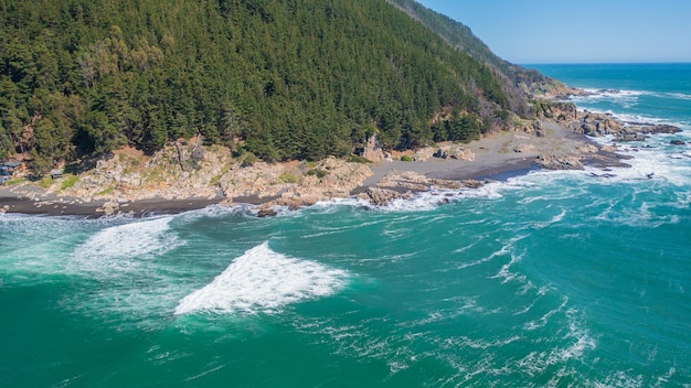 Photo caleta pellines, constitucion, maule, chile, horizontal drone aerial photo, sea, beach, hill and forest, chilean surf spot