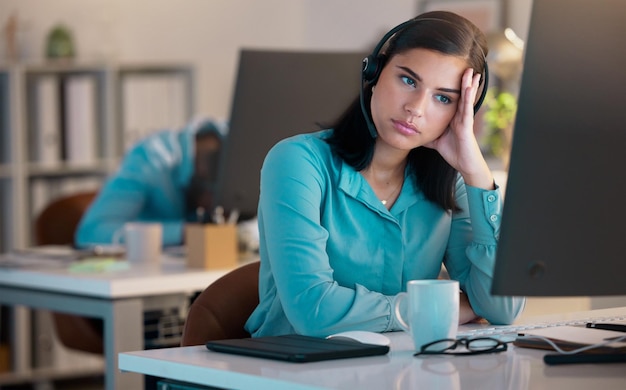 Call center bored and tired woman in office for customer service or support at night Telemarketing computer and fatigue of female sales agent burnout consultant or lazy employee with crm deadline