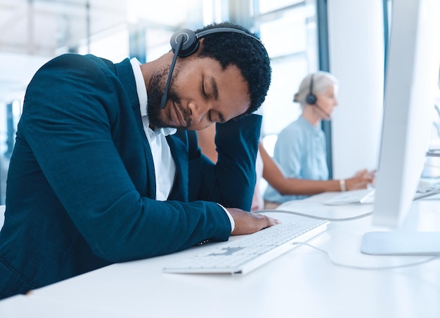 Call center burnout sleeping man and employee exhausted after long hours telemarketing or customer service consulting Company office agent help desk consultant or contact us worker tired at work