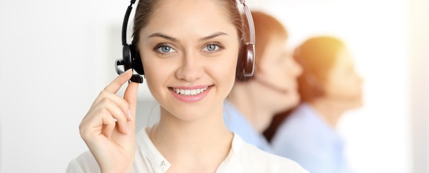 Call center. Diverse customer service operators in headsets at work in office. Business concept.