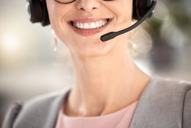 Call center face mouth and smile of telemarketing woman customer service office or communication agency Closeup happy sales consultant receptionist and customer support contact us and consulting