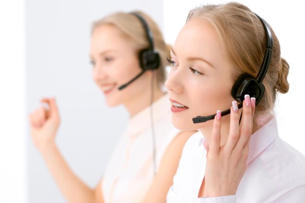 Call center. Focus on beautiful blonde woman in headset.