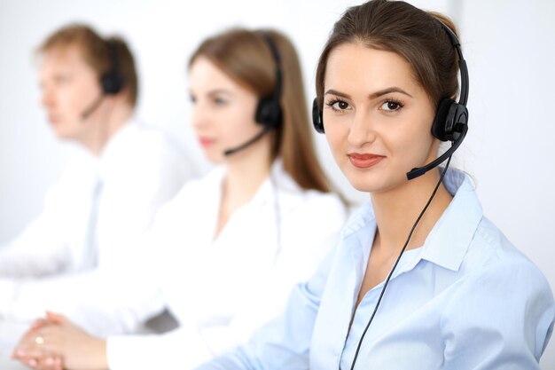 Call center. Focus on beautiful business  woman in headset.