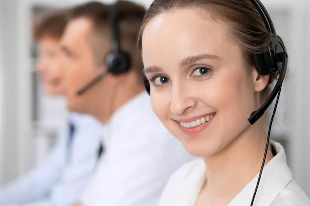 Call center. Focus on beautiful woman in headset.