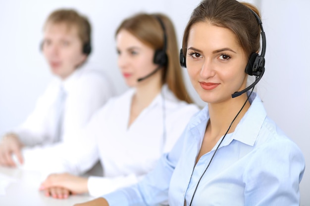 Call center. Focus on beautiful woman in headset.