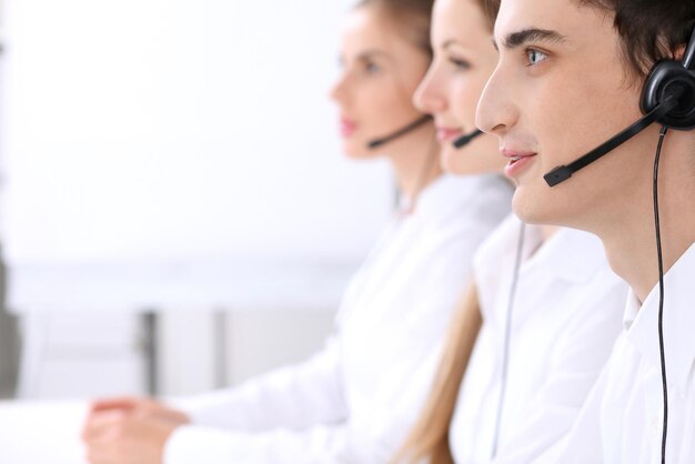 Call center. Focus on a man in headset.