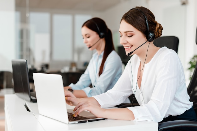 Call center operator answering clients in a company with tech support 